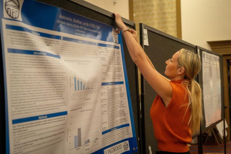 A poster presenter at the NIJ Research Conference