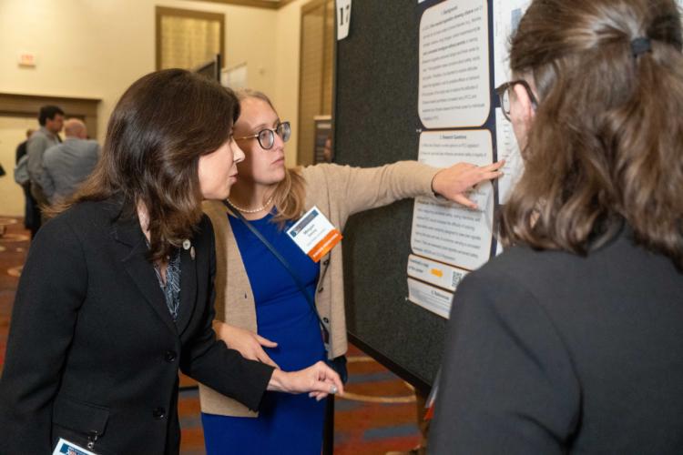 NIJ Director Nancy La Vigne chats with poster presenters