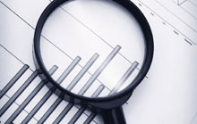 Magnifying glass over bar chart
