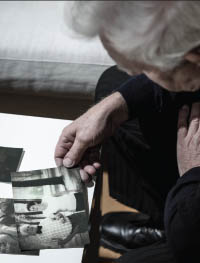 Older gentelman looking at a photograph