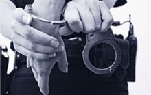 Officer putting cuffs on a suspect