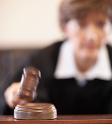Judge striking with a gavel.