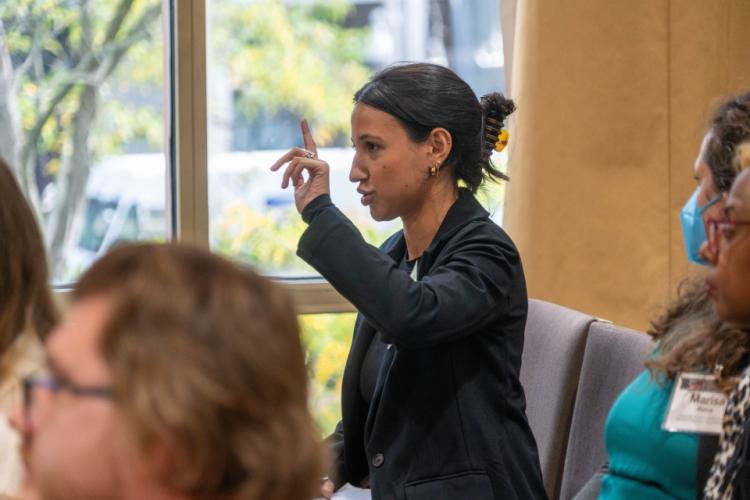 A conference attendee participants in Q&A after a panel
